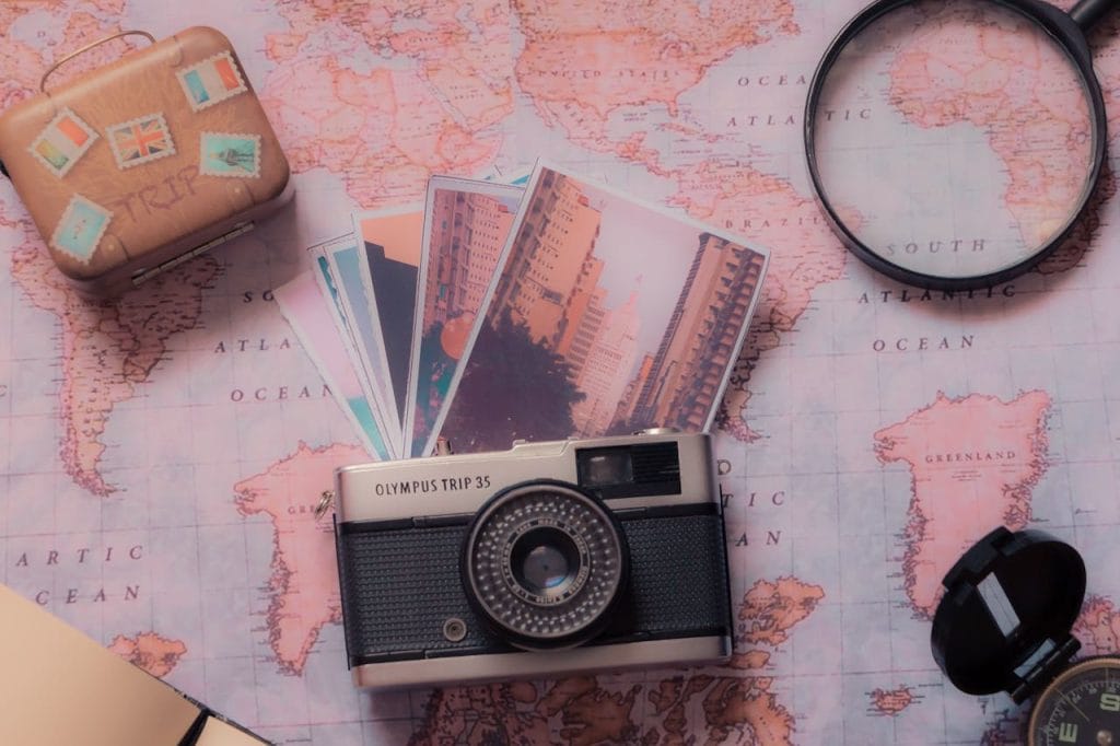 Explore vintage photography with a classic camera and travel-themed setup over a world map.